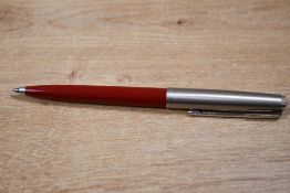 A Parker 61 ballpoint pen in red with lustraloy cap and chrome trim