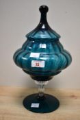A 20th-century studio glass Empoli-style bonbonnière jar, in a deep teal hue, featuring a circus
