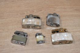 Two mid 20th-century Ronson Milady mother-of-pearl inset cigarette lighters; sold with a Hestia Baby