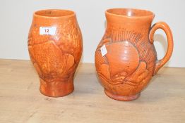 Two 20th-century Crown Ducal orange pottery wares, to feature a small vase and a ewer, both having a