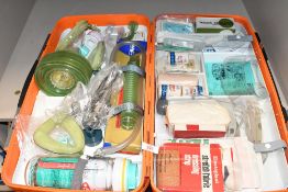 A large vintage First Aid Kit, containing various medical supplies, with clear plastic