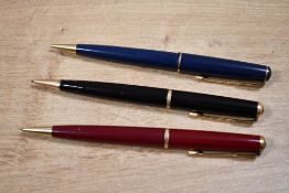 Three Parker 17 propelling pencils in black, red, and blue.