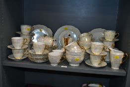 A large early 20th-century Czechslovakian ceramic lustre ware part tea and dinner set, featuring