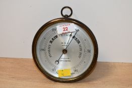 A small early 20th-century M.D.S London brass cased Aneroid Barometer, marked to back and front,