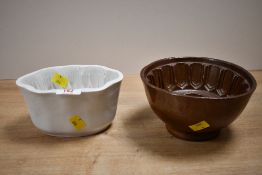 Two late 19th-century to early 20th-century ceramic jelly moulds, to feature a decorative fruit