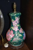 A 20th century Chinese porcelain famille vert style baluster table lamp, decorated with lotus and