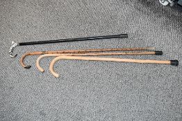 Four 20th-century walking canes, to feature three wooden examples and one other, unmarked, all
