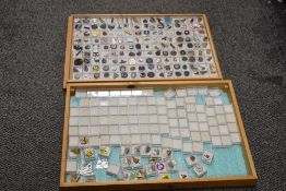 A large collection of 20th century metal and enamel pin badges, stored in two wooden storage
