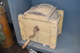 A 19th-century wooden butter churn with a hand crank mechanism, featuring a rectangular body and a