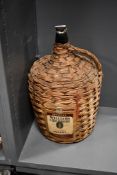 A large vintage William and Humbert 'Cedro' Sherry wicker-wrapped glass demi John bottle, empty,