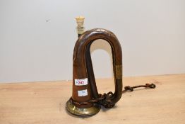 A 20th-century copper and brass military bugle, featuring a bone mouthpiece and a deep green, blue