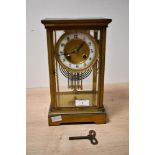 A late 19th to early 20th-century French-style four glass mantel clock, featuring a brass case