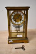 A late 19th to early 20th-century French-style four glass mantel clock, featuring a brass case