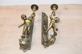 Two late 19th to early 20th-century French-style brass Putti wall sconces, featuring floral
