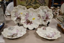 Five late 19th-century French Alfred Lanternier Limoges porcelain scalloped plates, featuring