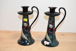 Two early 20th-century Decoro pottery candlesticks, featuring a pair of colourful tropical birds
