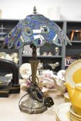 A late 20th-century Loxton Lighting Limited Peacock Tiffany-style table lamp, featuring a