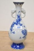 A vintage blue and white Chinese style vase having moulded lion handles 9.5cm high.