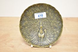 A 20th-century brass peacock jewellery dish, featuring an array of embossed outstretched tail
