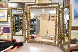 A vintage gilt-framed triple mirror, with moulded foliate decoration 63cm high