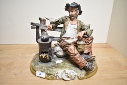 A large Capodimonte 'Tramp on Bench' featuring a log burner and crumb fed seagulls, measuring 24.5cm