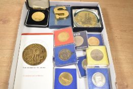 An assortment of commemorative crowns and medals together together with a paperweight, mostly