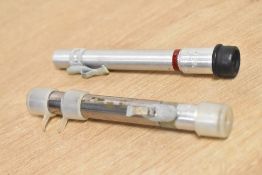 Two dosimeters, instruments to measure your exposure to radiation.