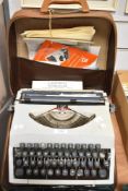 An imperial messenger portable typewriter sold with a beginners keyboard manual etc.