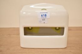 A vintage Jeyes ceramic toilet paper holder, wall mounted and designed to accomodate flat-pack Jeyes