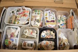A carton of world stamps on/off paper and in tubs, good world collection.