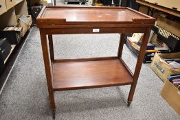 A vintage stained wood two-tier tea trolley, of typical design with shallow galleried top 75cm x