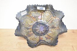 A 20th-century Fenton carnival glass bowl in Amethyst/purple having a ruffled rim, featuring