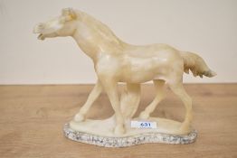 A hand-carved onyx stone stallion study on a raised marble style base, measures 17cm tall, having