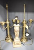 Two 20th-century brass candelabra-style table lamps; sold with a resin draping swag and ribbon-motif