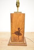 A late 20th-century wooden table lamp, featuring a selection of pyrogravure ballerina silhouettes,