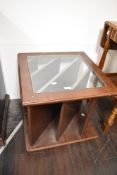 A mid-century teak coffee table/magazine rack with a floating glass top 51cm x 51cm x 48cm.