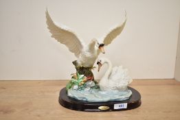 A large Juliana Collection swan group study, depicting two swans near a water feature, raised on a