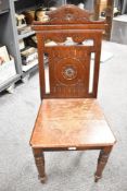 A late Victorian mahogany hall chair (seat worn and frame a little loose)