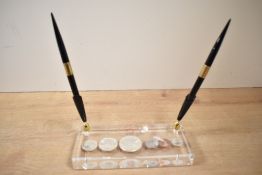 A vintage Canadian 1967 Centennial coin set encased in a lucite pen holder, featuring six