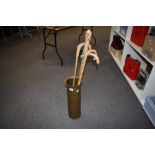 A Large copper shell case made into a stick stand measuring 51cm high and containing 4 assorted