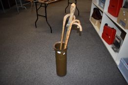 A Large copper shell case made into a stick stand measuring 51cm high and containing 4 assorted