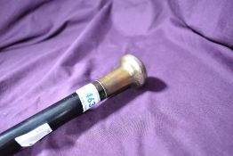An ebonised swagger stick with hallmarked silver top