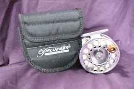 A pflueger 3.5inch 2856 fly reel in a neoprene pouch showing very little signs of wear