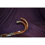 Two walking canes one measuring 90cm long and having a silver hallmarked ferule and a silver