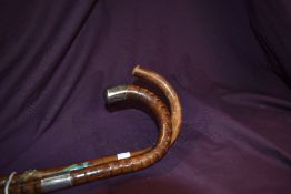 Two walking canes one measuring 90cm long and having a silver hallmarked ferule and a silver