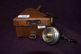 An Illingworth No 3 casting reel in its original triangular fitted box with leather strap