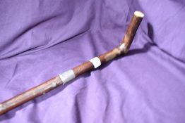 A hazel walking stick measuring 90 cm long with rubber foot and a silver ferule inscribed 'W. Wright