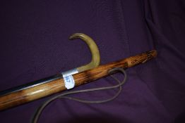 A walking stick with the handle carved in the style of a prairie dog measuring 105cm along with