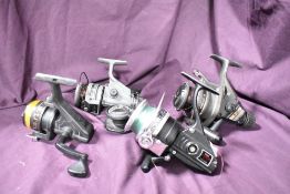 Four spinning reels A Shakespeare mk 2 graphite, a Isuzu charger x-3, a Trail SE-420 and a Shimano
