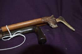Two walking sticks one with an antler handle and the other a bone handle measuring 78cm & 88cm and a